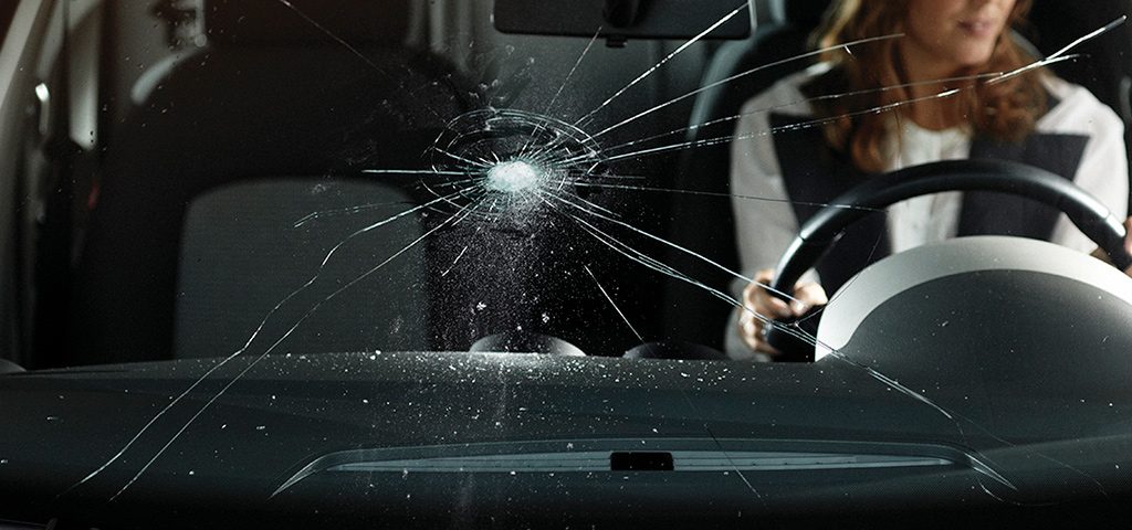 What causes cracks in the windshield of cars